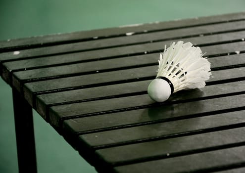 Shuttle cock on wooden table in the badminton court