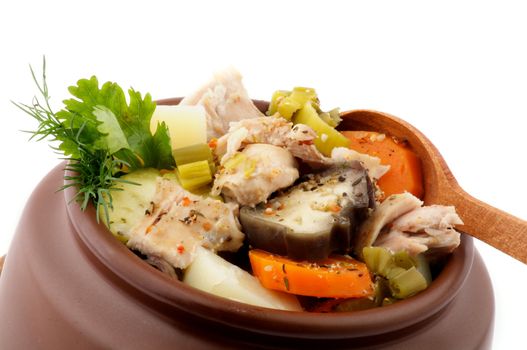 Hearty Vegetable and Chicken Stew in Brown Pot with Wooden Spoon isolated on white background