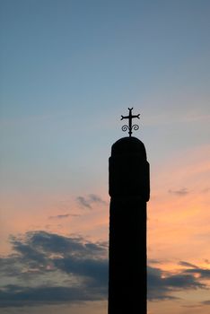           Old chapel with Cross silhouette at sunset 