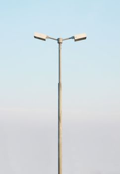 double street light lamp post with blue sky background