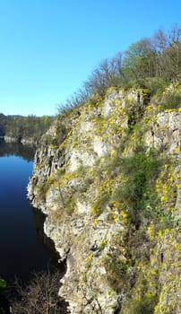Beautifull natural landscape with rocks, lake and yellow flowers