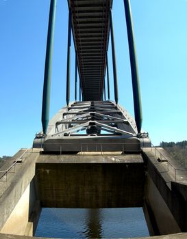 Detail of a bridge with metal arch and heavy pillars