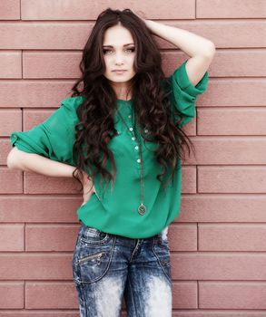 Young elegant woman in front of brick wall backround