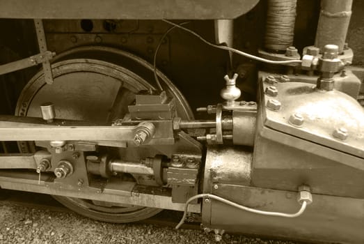 Wheels of an old locomotive in a warm sepia tint