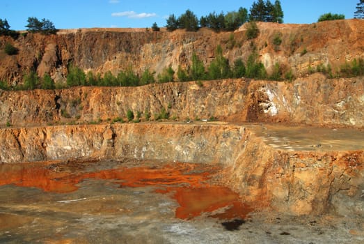 Old limestone quarry partially flooded with water