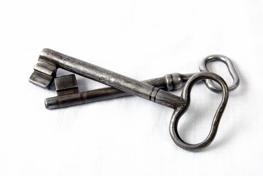 Two antique rusty keys isolated on a white 