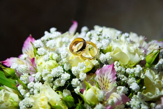 Wedding rings on a bridal bouquet