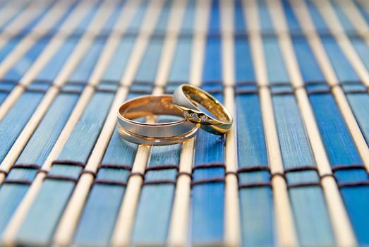 Two wedding rings on a striped mat