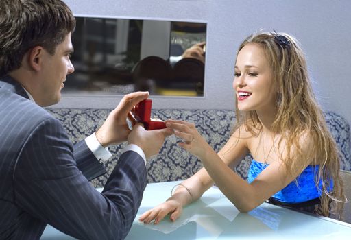 close up of young couple getting engaged at the restaurant