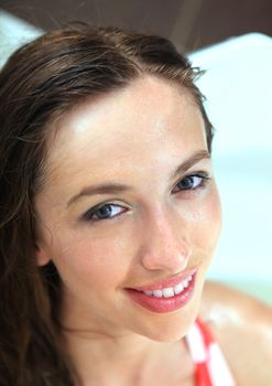 Close-up smiling face of young adult beautiful woman