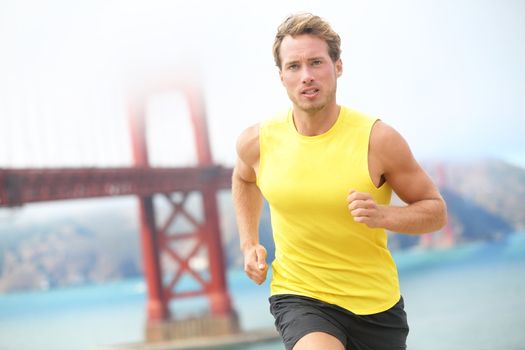 Running in San Francisco. Athlete runner working out jogging by Golden Gate Bridge, San Francisco, USA. Young fit caucasian sport fitness model.