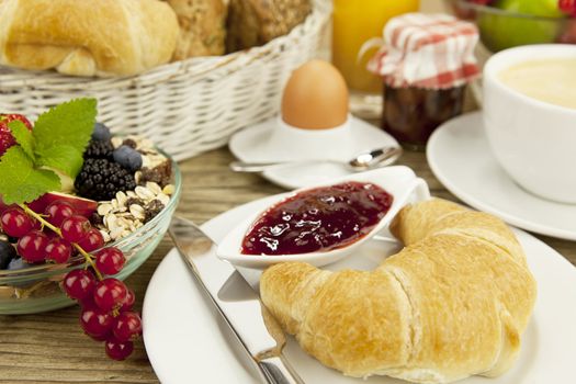 traditional french breakfast in morning on wooden background