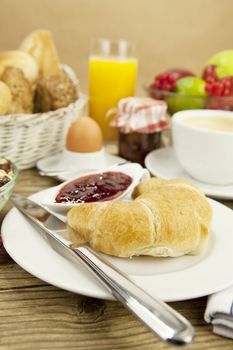 traditional french breakfast in morning on wooden background