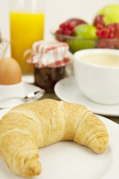 traditional french breakfast in morning on wooden background