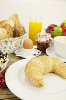 traditional french breakfast in morning on wooden background