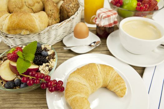 traditional french breakfast in morning on wooden background