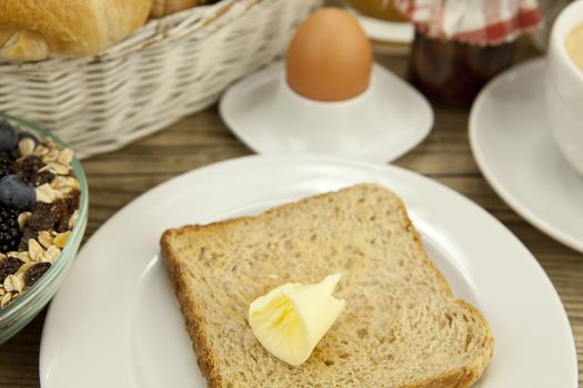 traditional french breakfast in morning on wooden background