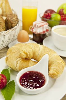 traditional french breakfast in morning on wooden background