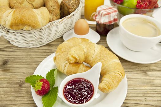 traditional french breakfast in morning on wooden background