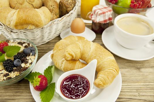 traditional french breakfast in morning on wooden background