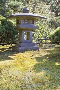 Japanese Stone Lantern with Trees Shrubs and  Moss