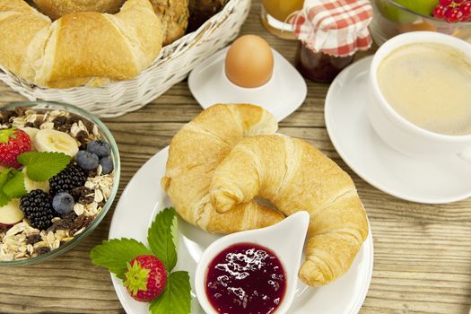 traditional french breakfast in morning on wooden background