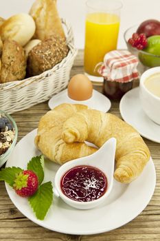 traditional french breakfast in morning on wooden background