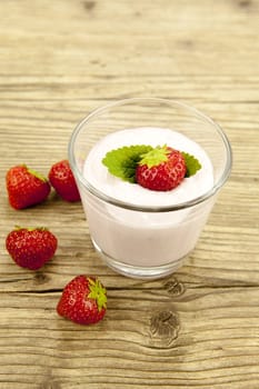 fresh tasty strawberry yoghurt shake dessert on wooden background