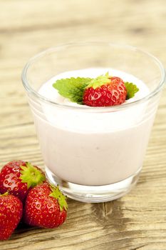 fresh tasty strawberry yoghurt shake dessert on wooden background