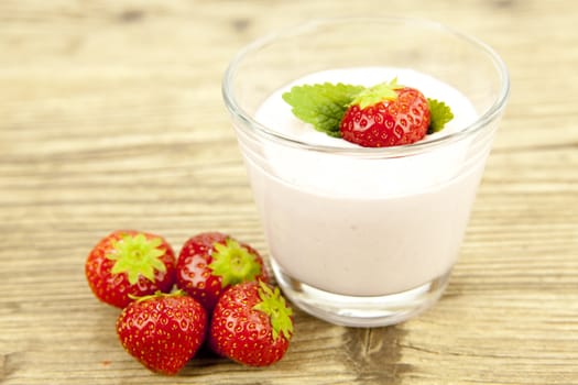 fresh tasty strawberry yoghurt shake dessert on wooden background