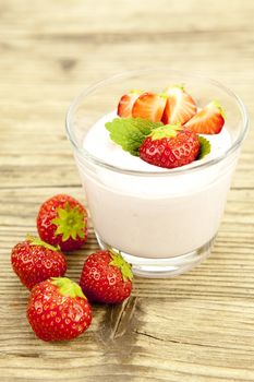 fresh tasty strawberry yoghurt shake dessert on wooden background