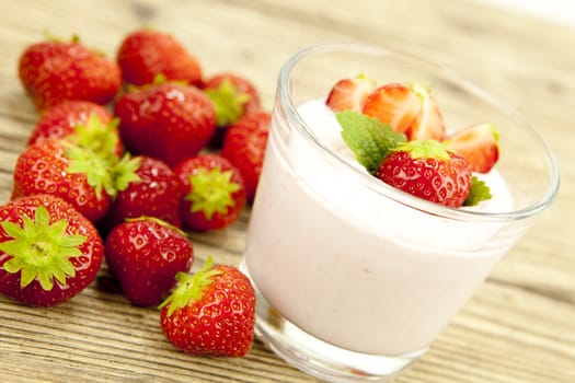 fresh tasty strawberry yoghurt shake dessert on wooden background