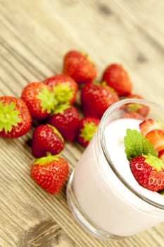 fresh tasty strawberry yoghurt shake dessert on wooden background