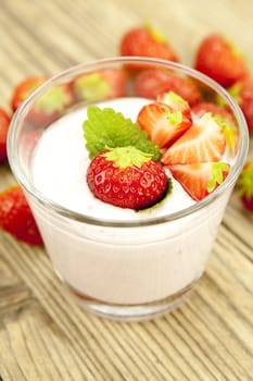 fresh tasty strawberry yoghurt shake dessert on wooden background