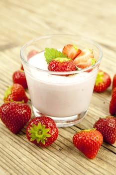 fresh tasty strawberry yoghurt shake dessert on wooden background