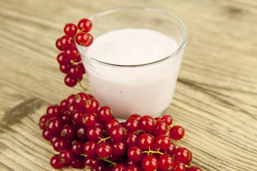 deliscious fresh currant yoghurt shake dessert on wooden background