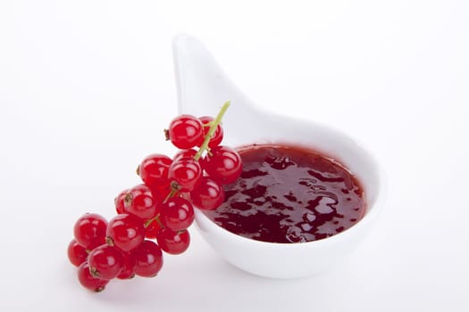 tasty fresh red currant jam isolated on white background