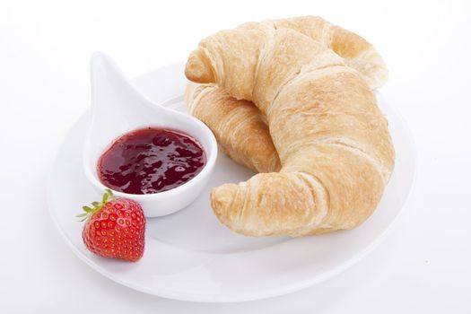 deliscios fresh croissant with strawberry jam isolated on white background