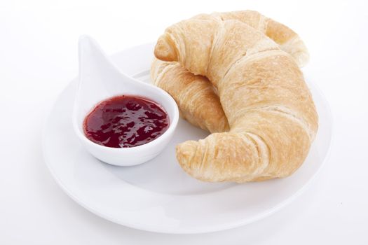 deliscios fresh croissant with strawberry jam isolated on white background