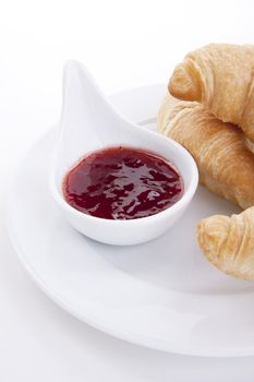 deliscios fresh croissant with strawberry jam isolated on white background