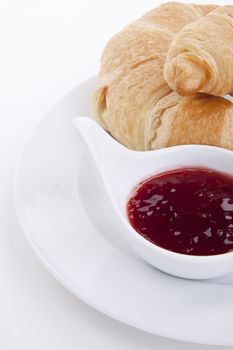 deliscios fresh croissant with strawberry jam isolated on white background