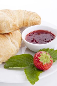 deliscios fresh croissant with strawberry jam isolated on white background