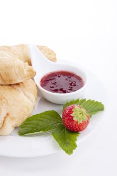 deliscios fresh croissant with strawberry jam isolated on white background