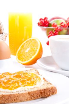 breakfast table with toast and orange marmelade isolated on white background