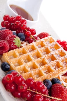 sweet fresh tasty waffles with mixed fruits isolated on white background