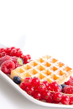 sweet fresh tasty waffles with mixed fruits isolated on white background