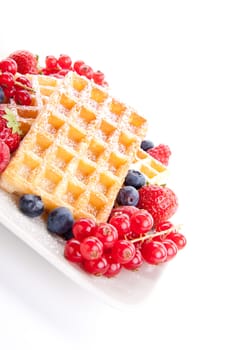 sweet fresh tasty waffles with mixed fruits isolated on white background