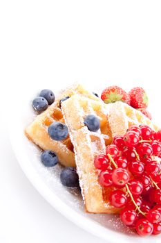 sweet fresh tasty waffles with mixed fruits isolated on white background
