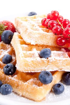 sweet fresh tasty waffles with mixed fruits isolated on white background