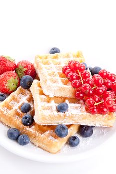 sweet fresh tasty waffles with mixed fruits isolated on white background
